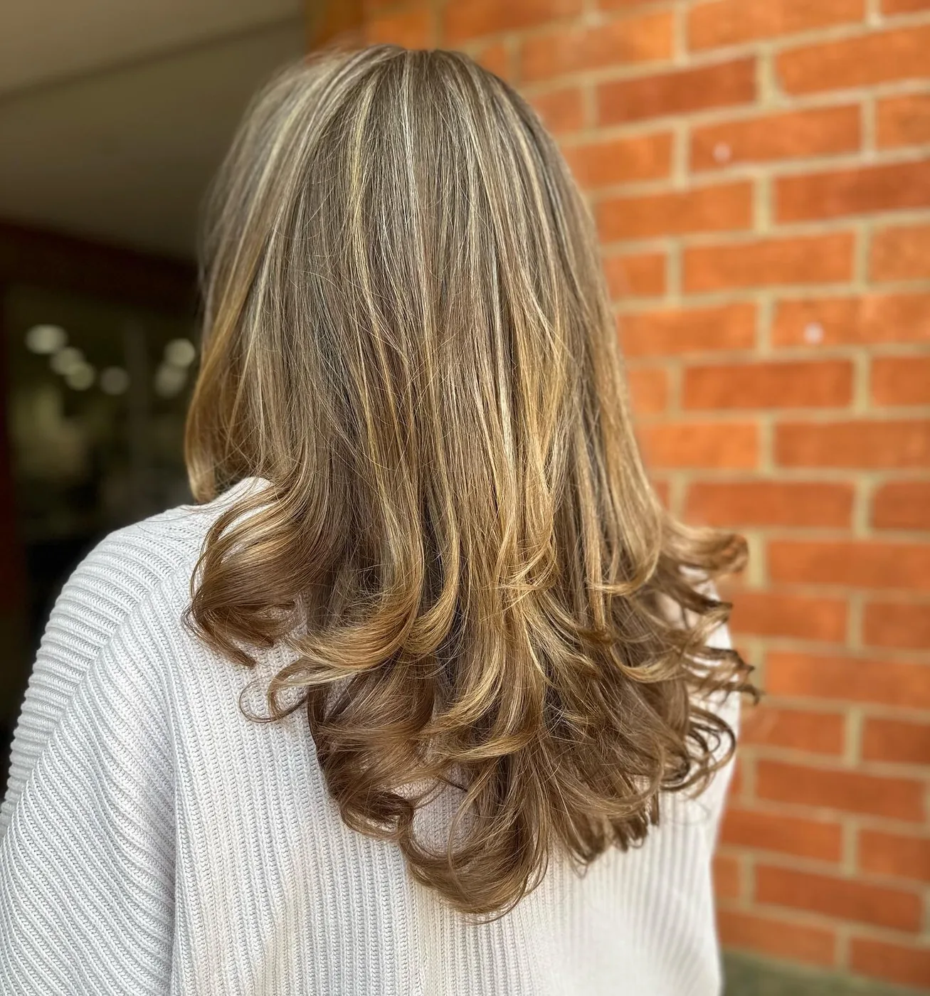 Soft blonde curls with highlights